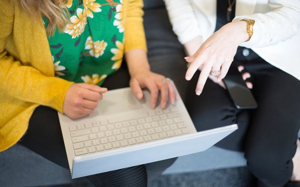 Two people working through a document at a keyboard